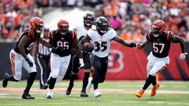 Baltimore Ravens running back Gus Edwards (35) carries the bal as Cincinnati Bengals defensive tackle Zach Carter (95) and Cincinnati Bengals linebacker Germaine Pratt (57) give chase in the first quarter of a Week 2 NFL football game between the Baltimore Ravens and the Cincinnati Bengals Sunday, Sept. 17, 2023, at Paycor Stadium in Cincinnati.  